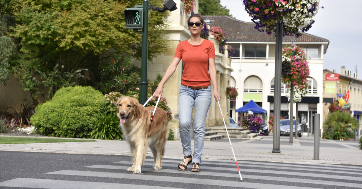 Blind woman crossing the street