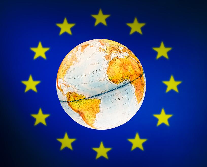 Image of globe in front of European flag
