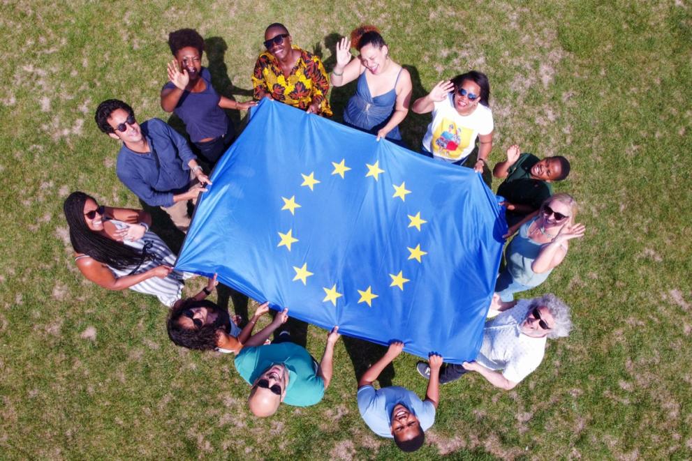 Young people holding the EU flag