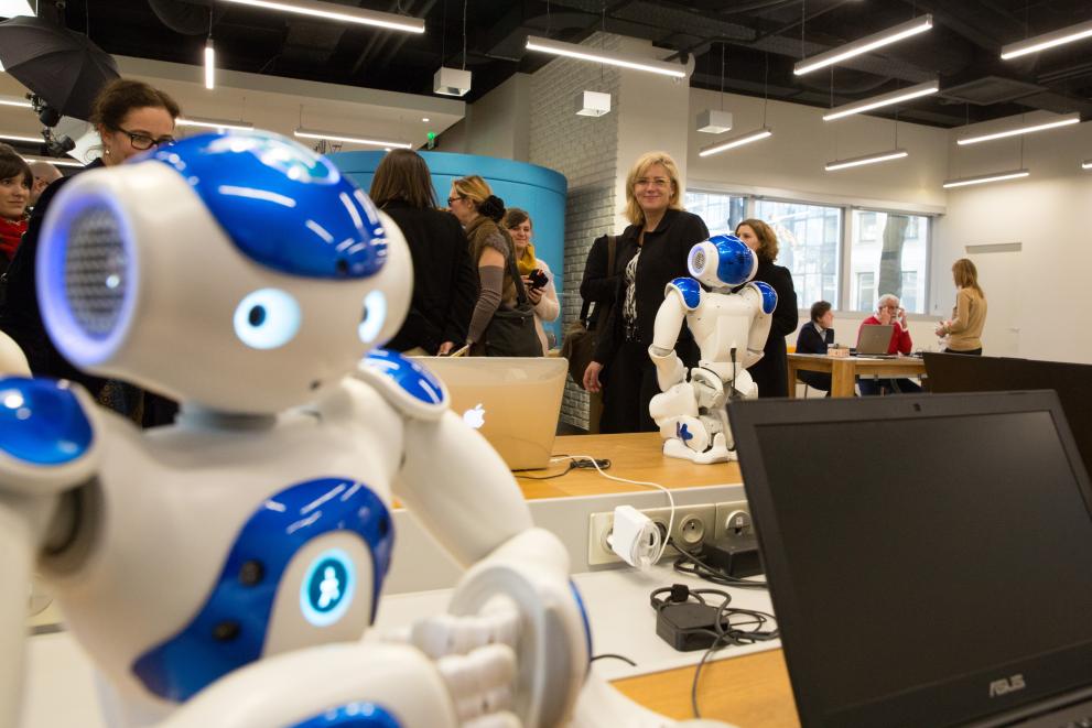 a blue and white robot at a conference