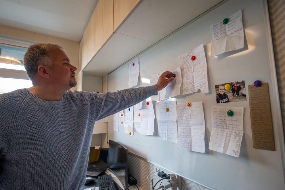 Konstantin Gudauskas, a Kazakh citizen, former journalist and human rights activist living in exile in Ukraine, examines pieces of paper with the names and details of 203 Ukrainian citizens he rescued from behind Russian frontlines north of the capital on April 30, 2022 in Kyiv, Ukraine