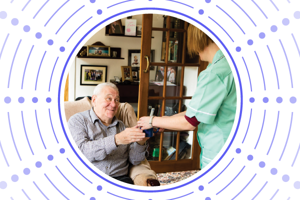 A nurse helps an elderly man in his home